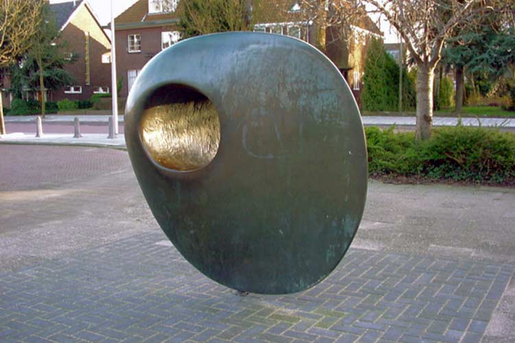 Bronze sculpture in Zwijndrecht 2009 - discoid form deposited on the public works yard.