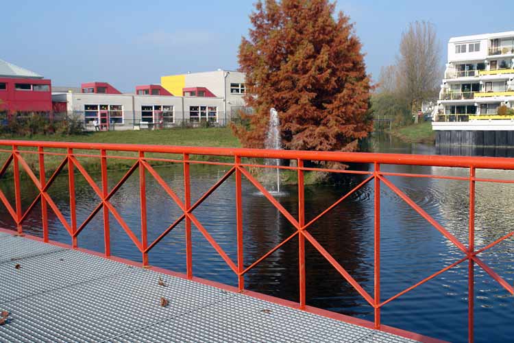 Dutch urban LAND ART in Ede - arched footbridge - 'Urban Oasis' - Bald Cypress trees (Taxodium Distichum), water, concrete and color.