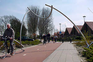 a sculpture traverses a bicycle route