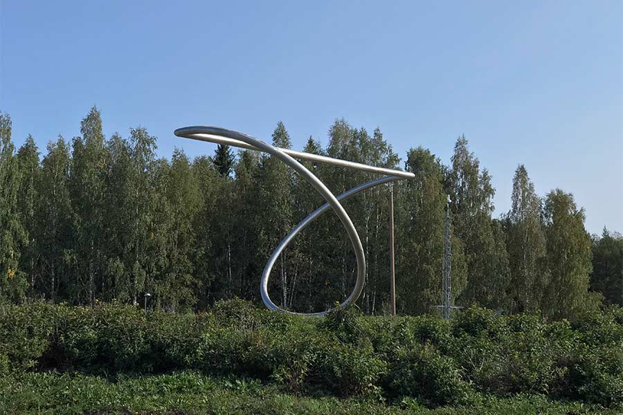 a roundabout sculpture in Kangasniemi, Finland - "QUISNAM·VERTITUR" 7x10x5m