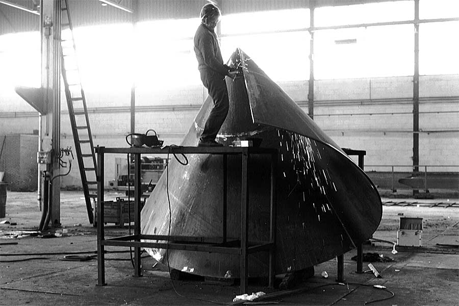 sculptor works on his rolled mild steel sculpture Gemini tango - construction